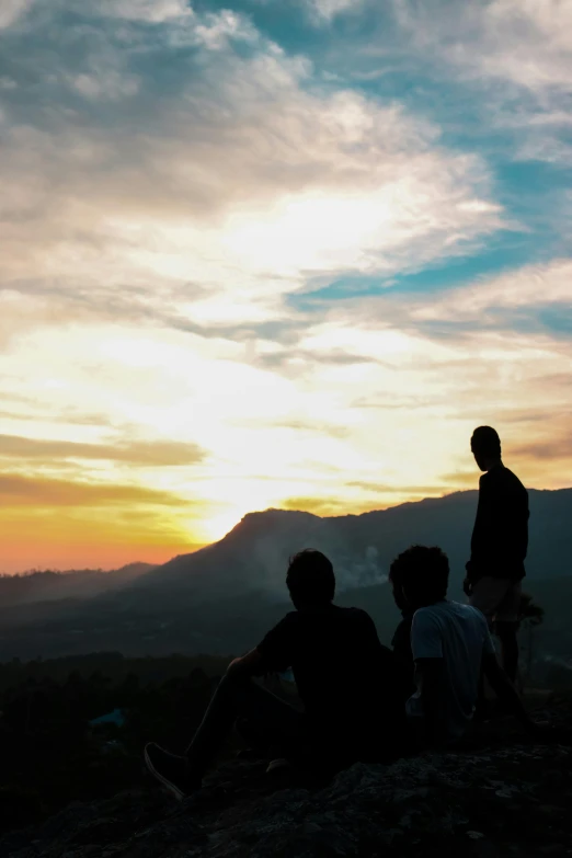 a group of people sitting on top of a mountain, during a sunset, sri lankan landscape, cute boys, instagram story