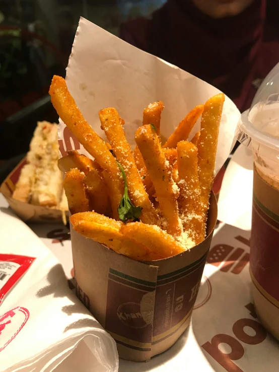 a basket of french fries next to a cup of coffee, inspired by Pia Fries, 🥥 🍕 hybrid, thumbnail, in sao paulo, exterior photo