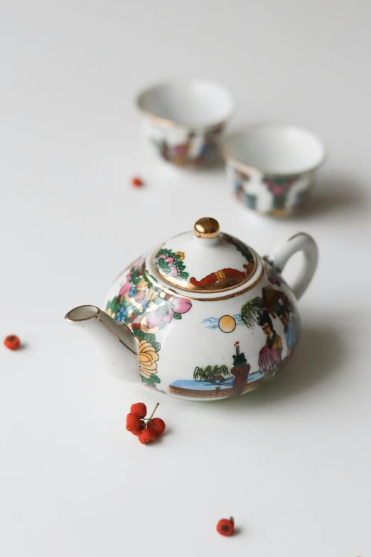 a tea pot sitting on top of a white table, a still life, inspired by Miyagawa Chōshun, instagram, cloisonnism, 3 - piece, chinese landscape, multi - coloured, thumbnail