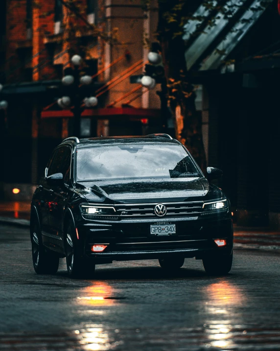 a black volkswagen suv driving down a city street, by Alexander Robertson, unsplash contest winner, front lighting, square, on a sidewalk of vancouver, lgbtq