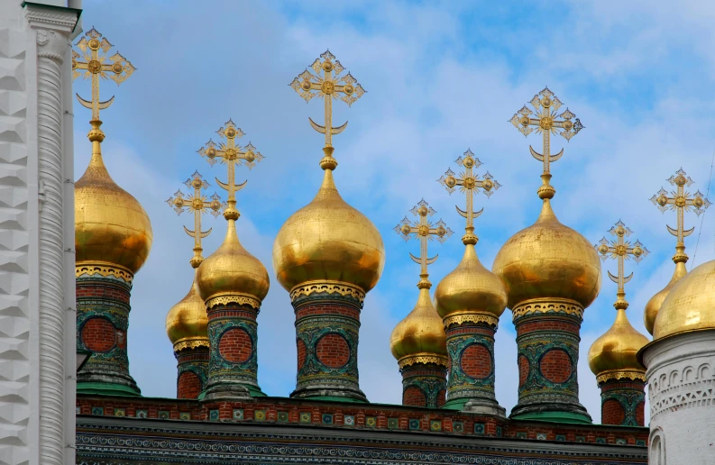 a group of golden domes on top of a building, an album cover, inspired by Vasily Surikov, pexels contest winner, square, crosses, spines, multicoloured