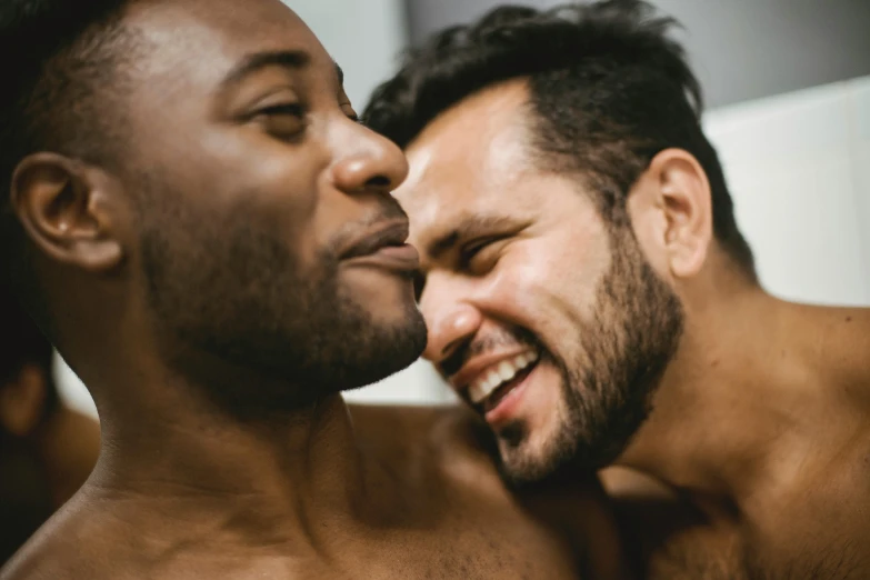 a couple of men standing next to each other, trending on pexels, licking out, with brown skin, prideful, close body shot