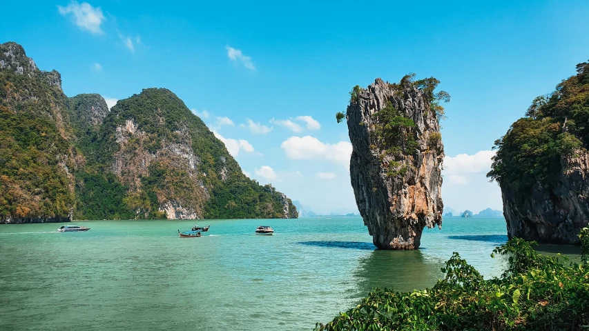 a group of boats floating on top of a body of water, thailand, square, chiseled formations, richard mille