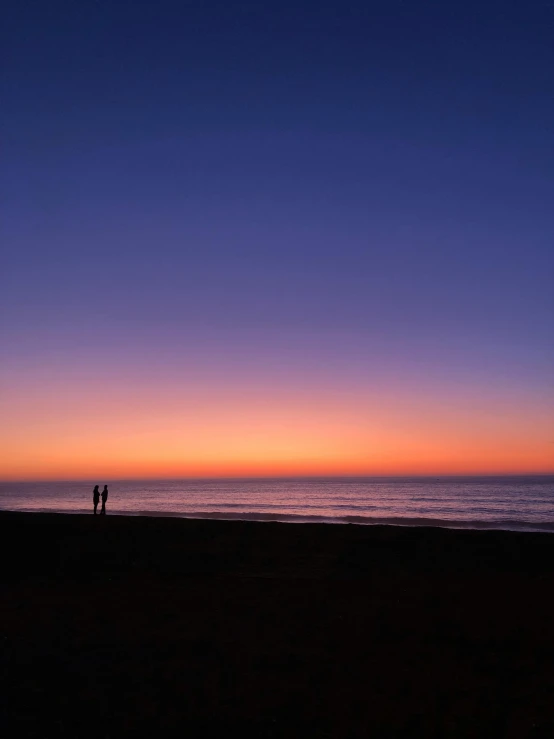 two people standing on a beach at sunset, deep purple and orange, at gentle dawn blue light, # nofilter, profile image