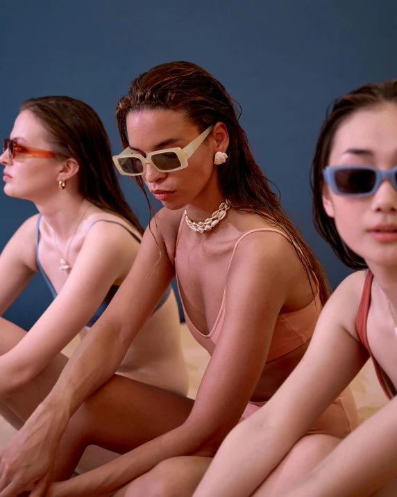 a group of women sitting next to each other, inspired by Ren Hang, trending on unsplash, wearing pearl neon bikini, wearing versace sunglasses, isolate translucent, her skin is light brown