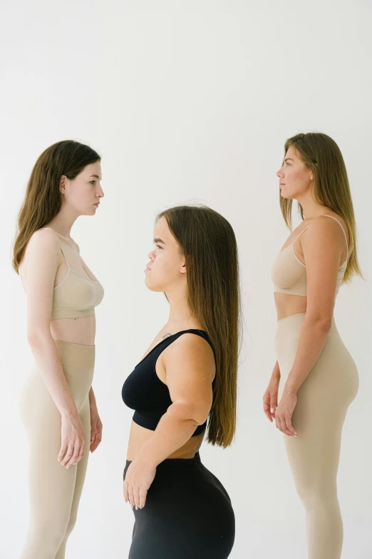 a group of women standing next to each other, inspired by Vanessa Beecroft, trending on unsplash, renaissance, side profile waist up portrait, training bra, young woman looking up, one blonde and one brunette