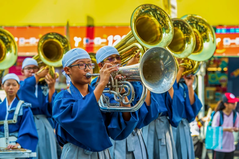 a group of people that are playing musical instruments, inspired by Shunkōsai Hokushū, pexels contest winner, hyperrealism, blue uniform, brass horns, slide show, yellow and blue ribbons