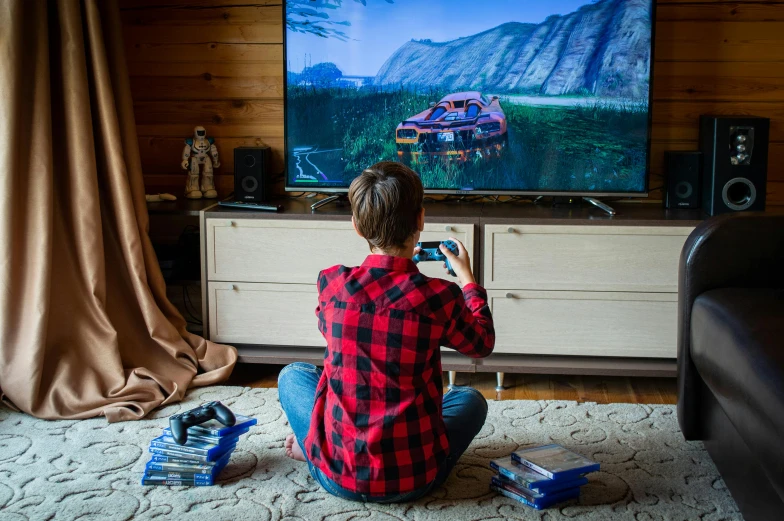 a person sitting on the floor playing a video game, by Julia Pishtar, pexels contest winner, hyperrealism, watching tv, stardew valley, shot from the back, teenage boy