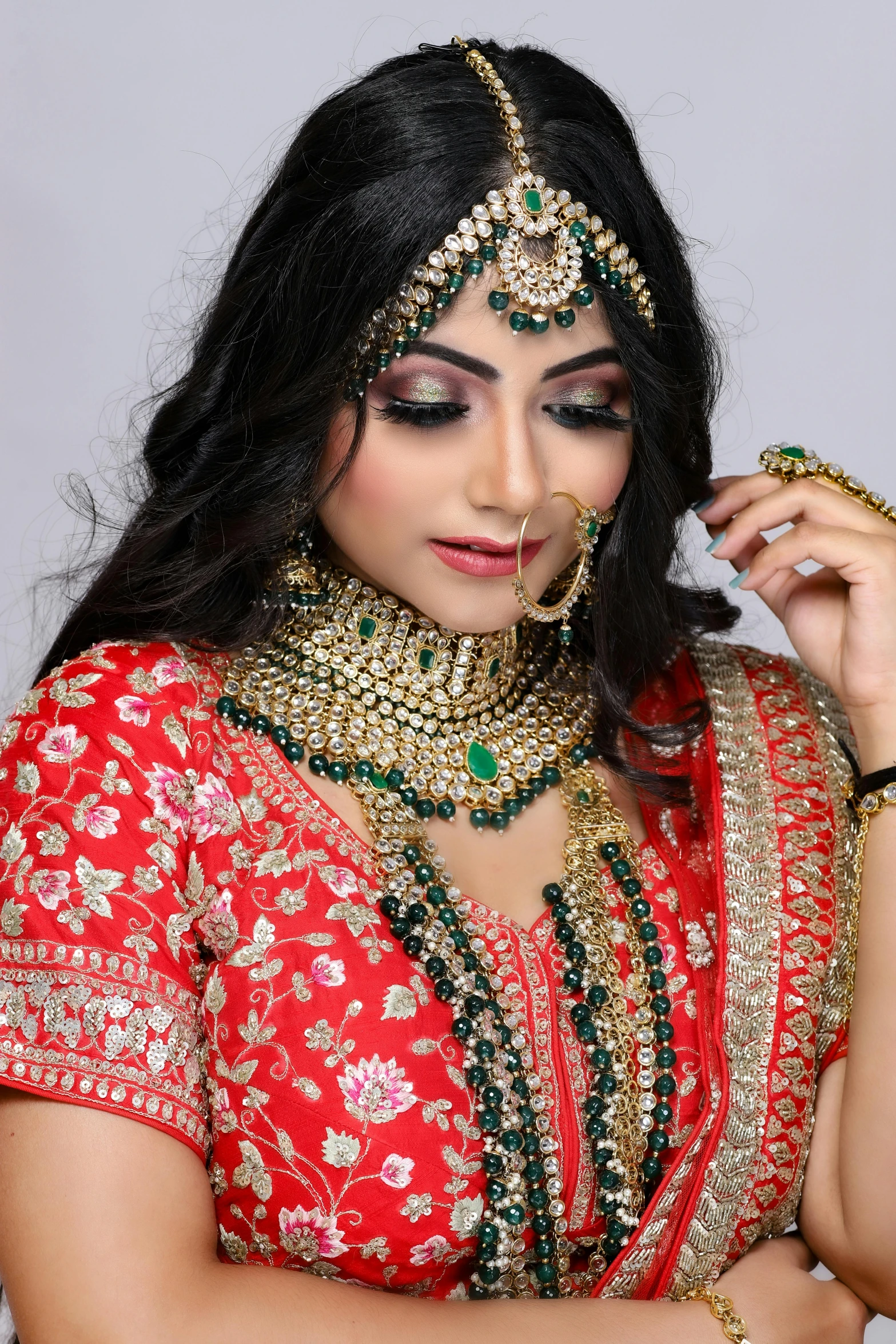 a woman in a red sari posing for the camera, inspired by Saurabh Jethani, gold and green, thumbnail, makeup, islamic