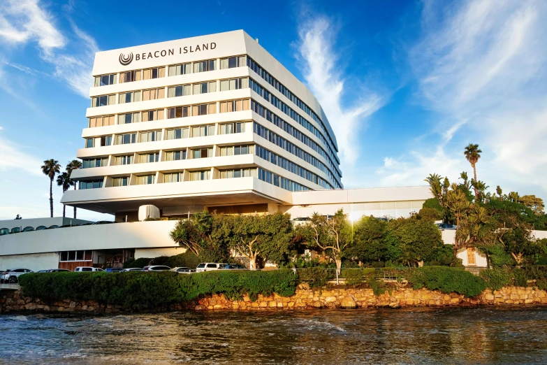 a large white building next to a body of water, a portrait, tv show, profile image, resort, highlights