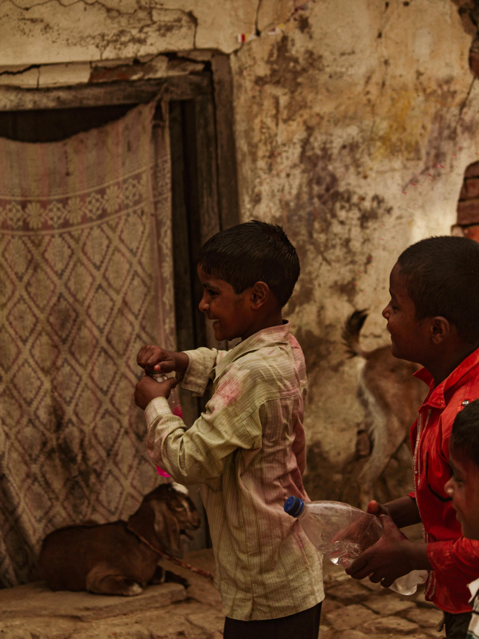 a group of children standing in front of a door, pexels contest winner, process art, kalighat, laundry hanging, low-light, ( ( theatrical ) )