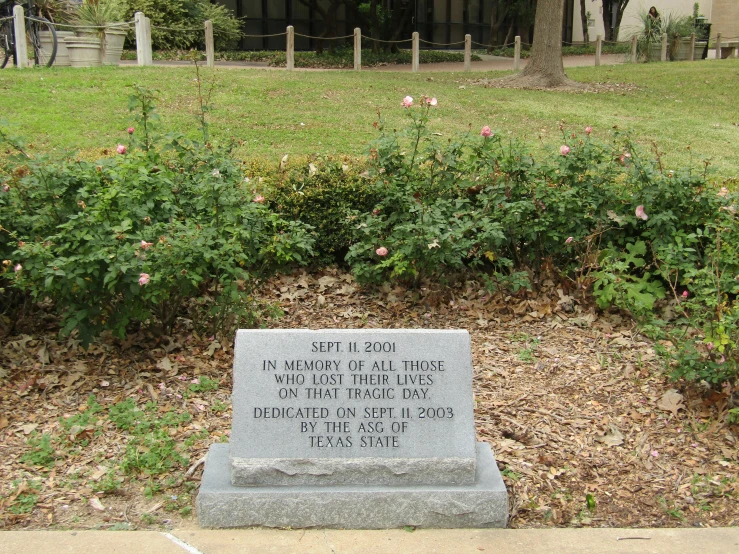 a memorial stone sitting in the middle of a park, sots art, jfk assassination, exterior botanical garden, from wikipedia, lady davis