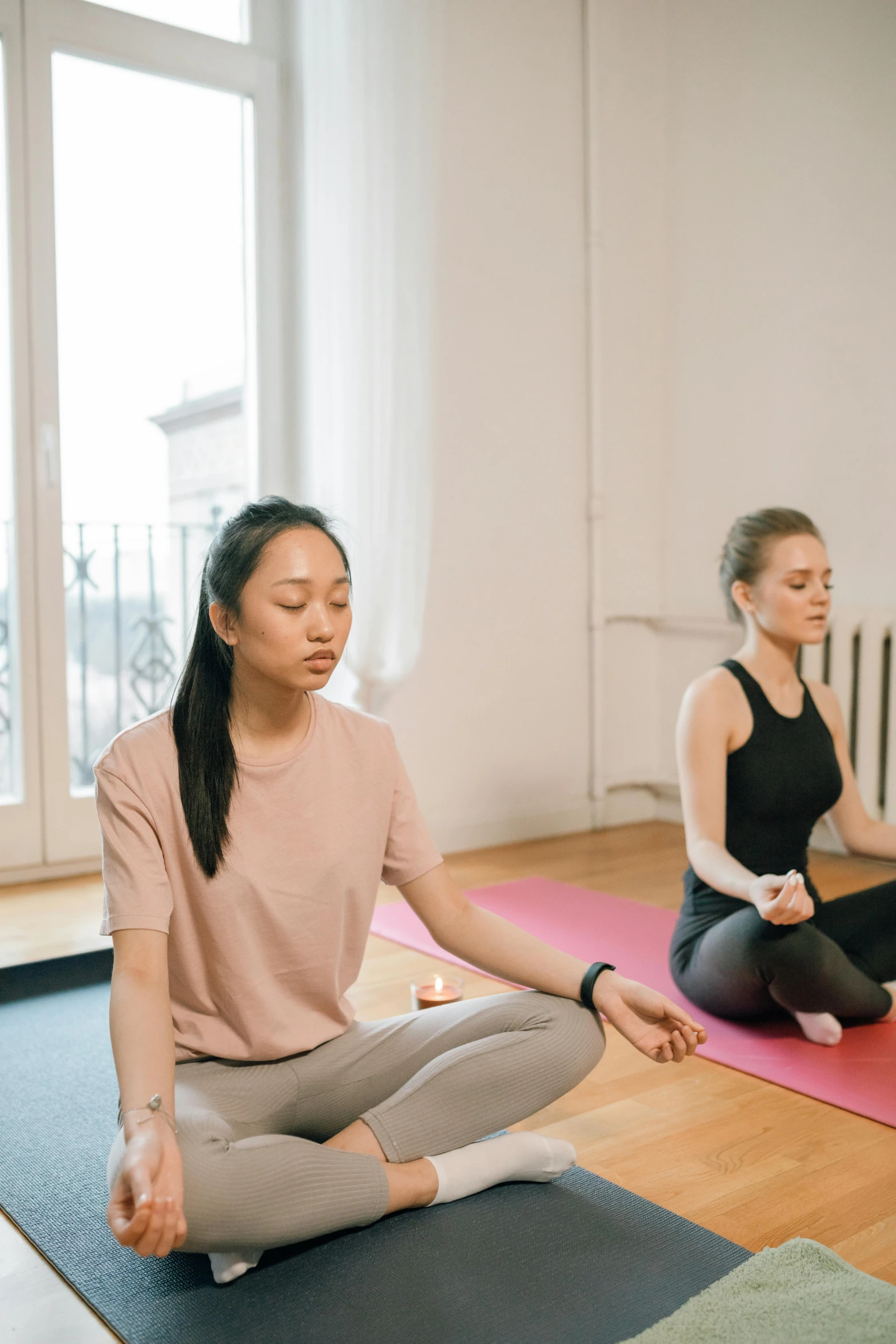 a couple of women sitting on top of a yoga mat, trending on pexels, renaissance, low quality photo, breathing, an asian woman, in the center of the image