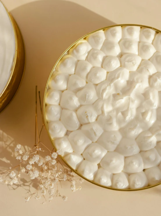 a bowl of marshmallows next to a plate of marshmallows, inspired by Marie-Gabrielle Capet, rococo, gold plated, diffused natural skin glow, detailed product image, lots of white cotton