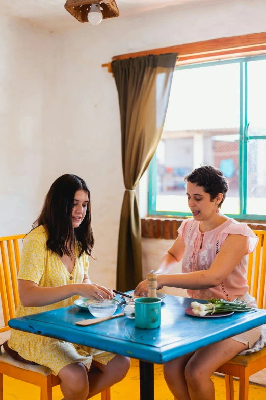 a couple of women sitting at a blue table, breakfast at las pozas, plating, rebecca sugar, square