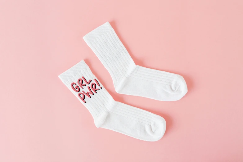 a pair of socks sitting on top of a pink surface, graffiti, gibli, cool white, full product shot, ((pink))