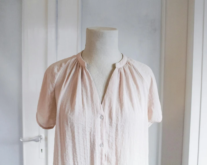 a close up of a dress on a mannequin, unsplash, figuration libre, cream colored peasant shirt, faded pink, button up shirt, thumbnail