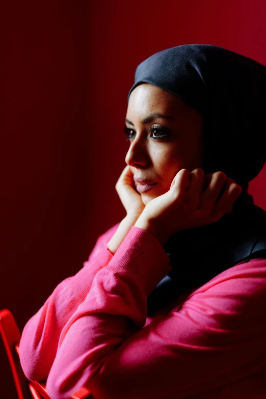 a woman sitting in front of a laptop computer, a portrait, inspired by Maryam Hashemi, flickr, hurufiyya, looking off to the side, photograph credit: ap, square, pink