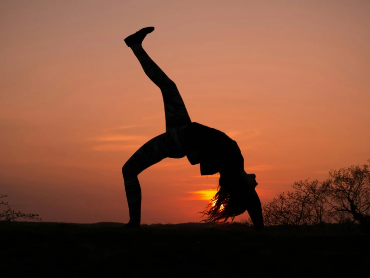 a person doing a handstand in the sunset, pexels contest winner, arabesque, avatar image, woman is curved, profile image, various bending poses