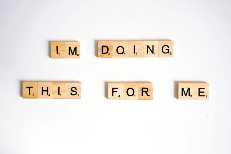 scrabbles spelling i'm doing this for me, a picture, by Matija Jama, trending on unsplash, letterism, background image, commission for, wood print, reassuring