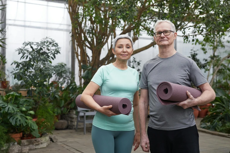 a man and a woman holding yoga mats, a photo, botanic garden, avatar image, portrait of hide the pain harold, local gym