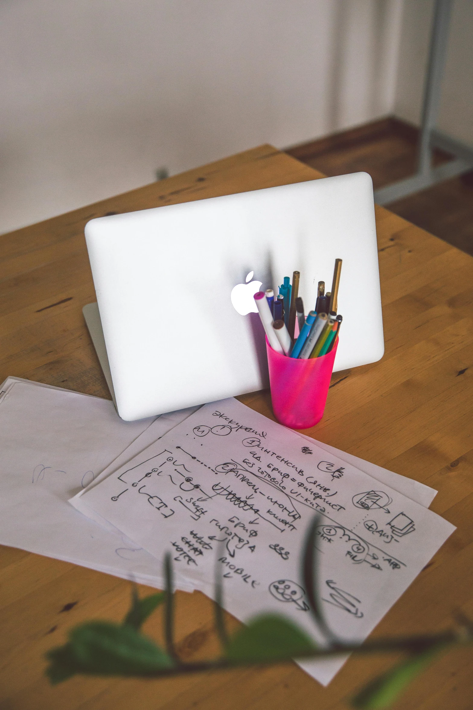 a laptop computer sitting on top of a wooden table, arbeitsrat für kunst, whiteboard, neon coloring, 9 9 designs, mid-view