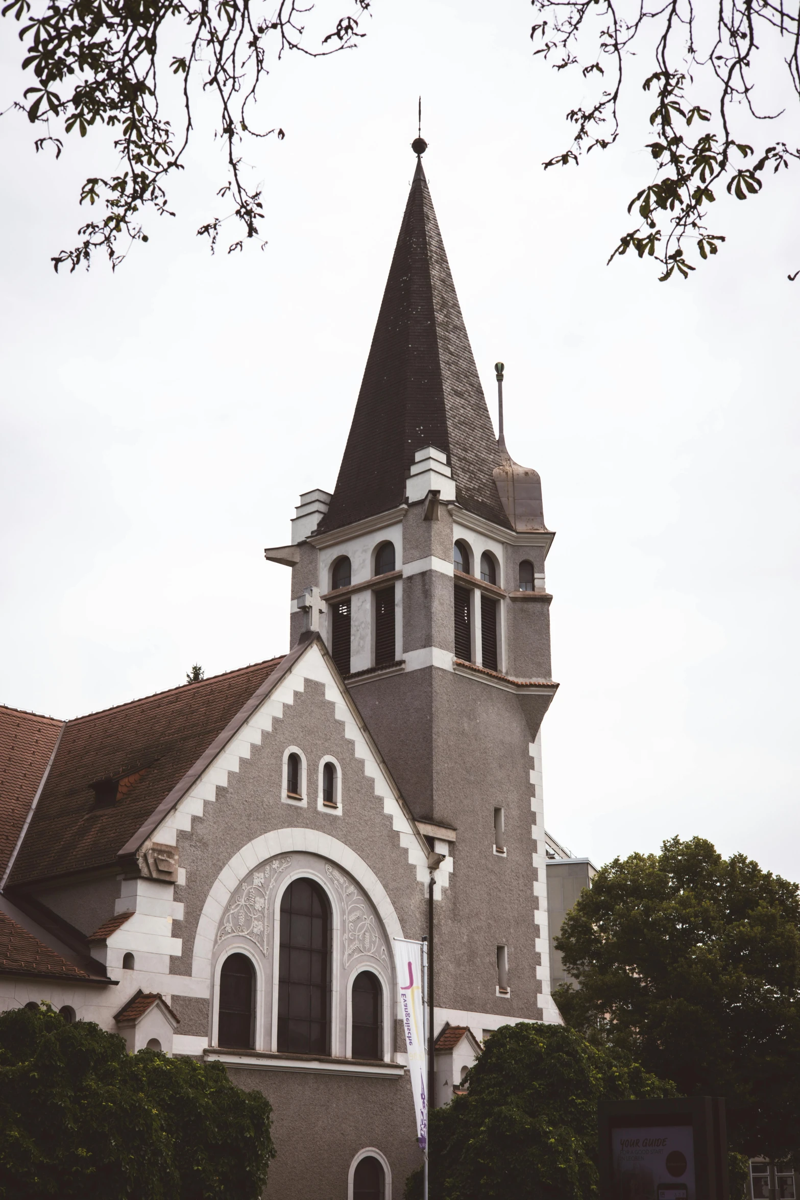a church with a steeple and a clock tower, unsplash, romanesque, grayish, 1990s photograph, reunion island, multiple stories