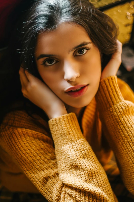 a woman in a yellow sweater posing for a picture, inspired by Elsa Bleda, trending on pexels, renaissance, somber amber eyes, brunette woman, indoor picture, teenage girl