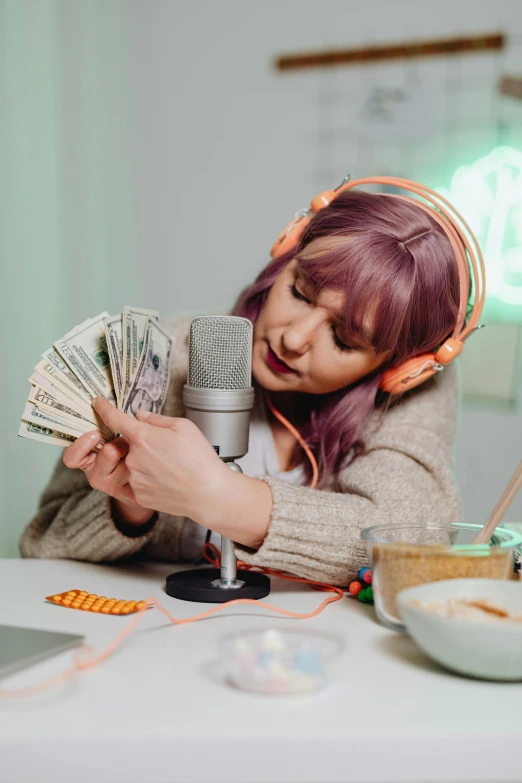 a woman sitting at a table with a microphone and money, by artist, trending on pexels, streaming on twitch, mukbang, high quality photo, (fantasy)