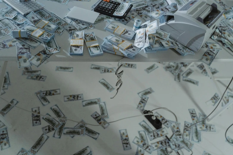 a laptop computer sitting on top of a pile of money, a hyperrealistic painting, by Jang Seung-eop, pexels contest winner, hyperrealism, reflections on a glass table, film still from the office, snake machine, scattered props