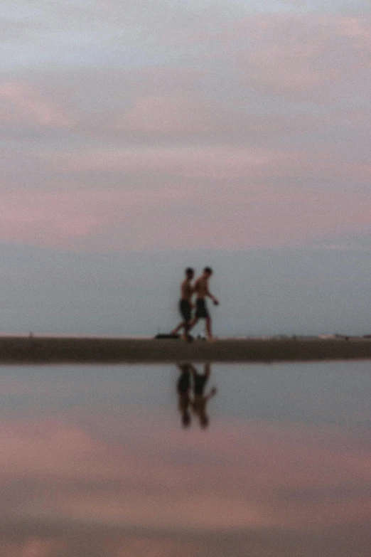 a couple of people that are walking on a beach, a picture, by Jan Tengnagel, mirrored, pink sunset, blurry footage, b - roll