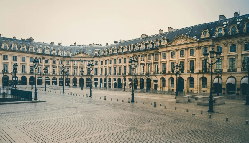 a square with a lot of buildings in the background, a photo, inspired by Pierre Brissaud, pexels contest winner, prefecture streets, hazy and dreary, royal palace, ground level shot