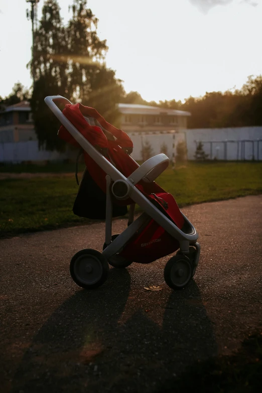 a baby stroller sitting on the side of a road, by Tadeusz Makowski, soft backlighting, at a park, toys, multiple stories