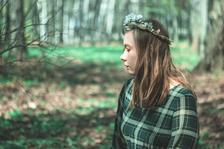 a woman standing in the woods with a flower crown on her head, inspired by Elsa Bleda, pexels contest winner, renaissance, wearing a plaid shirt, wearing green clothing, a lonely woman, teenage girl