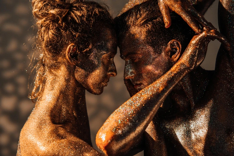 a couple of naked men standing next to each other, pexels contest winner, art photography, full of sand and glitter, orange skin. intricate, man and woman in love, covered in oil