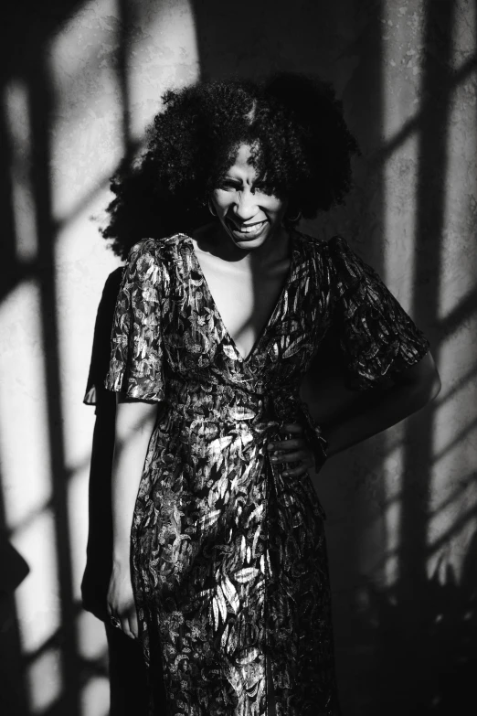 a black and white photo of a woman in a dress, an album cover, figuration libre, aida muluneh, with dappled light, in style of nan goldin, ((portrait))