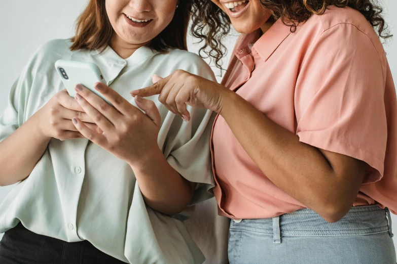 a couple of women standing next to each other, trending on pexels, happening, phone in hand, avatar image, playing games, ad image