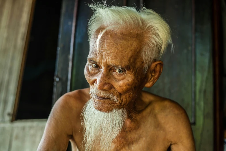 an old man with a long white beard, pexels contest winner, sumatraism, emaciated shaved face, asian male, looking across the shoulder, aged 2 5