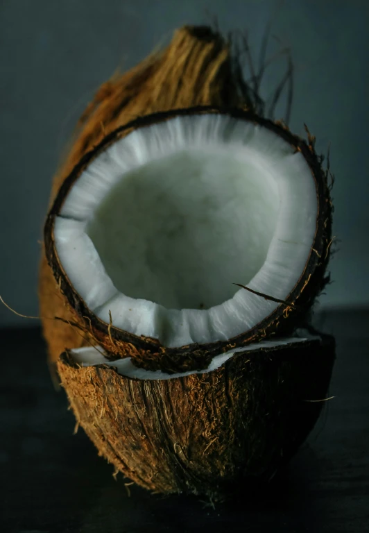 a half eaten coconut sitting on top of a table, by Adam Marczyński, unsplash, multiple stories, made of glazed, indoor picture, brazil