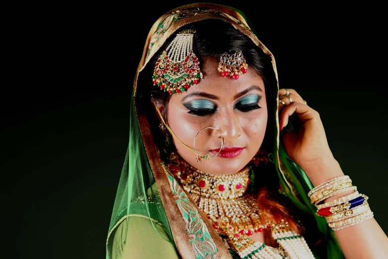 a woman in a green outfit posing for a picture, by Riza Abbasi, pixabay, art photography, traditional makeup, bride, square, close - up studio photo