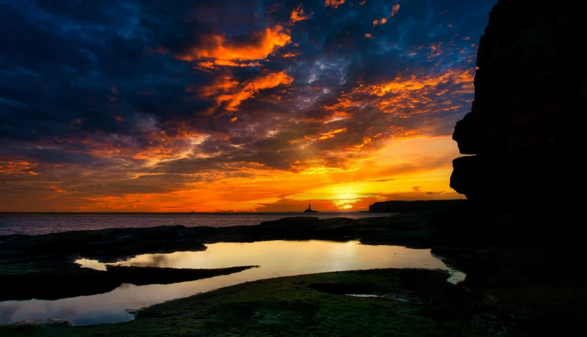 the sun is setting over a body of water, by Edwin Georgi, pexels contest winner, rock pools, vivid sky, hd footage, artistic photo