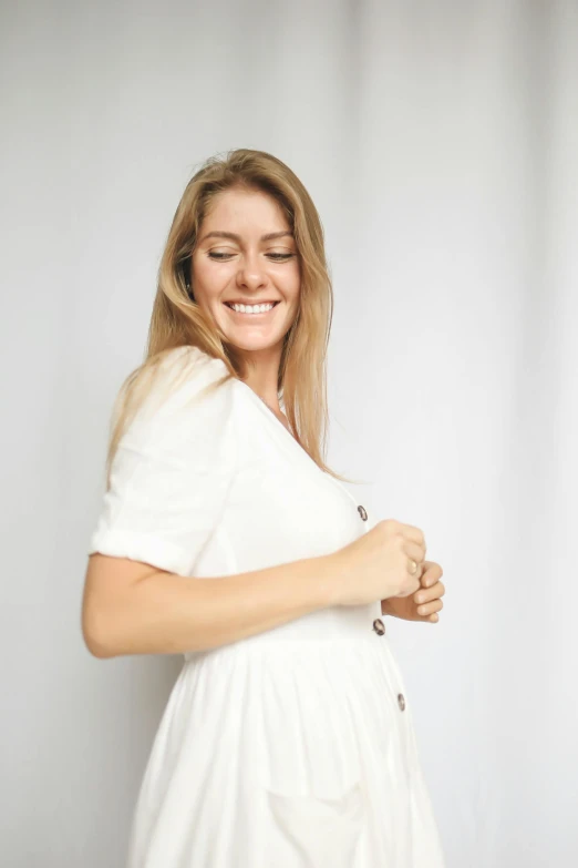 a woman in a white dress posing for a picture, laughing, white background : 3, wearing a white folkdrakt dress, third trimester