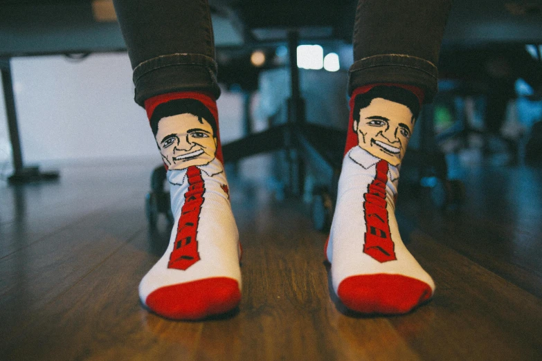a person wearing a pair of red and white socks, a cartoon, pexels, art brut, ben shapiro, agent cooper, friendly face, graphic print