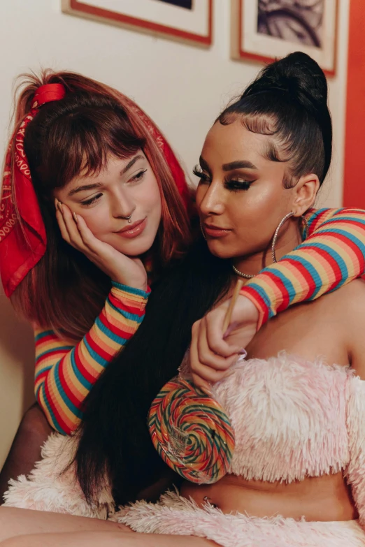 two women sitting on top of a bed next to each other, an album cover, trending on pexels, kitsch movement, left eye stripe, charli bowater, hugging each other, colourful clothing