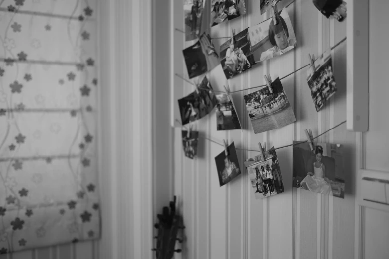 a black and white photo hanging on a wall, by Emma Andijewska, pexels contest winner, childhood memory, decoration around the room, detailed medium format photo, multiple stories