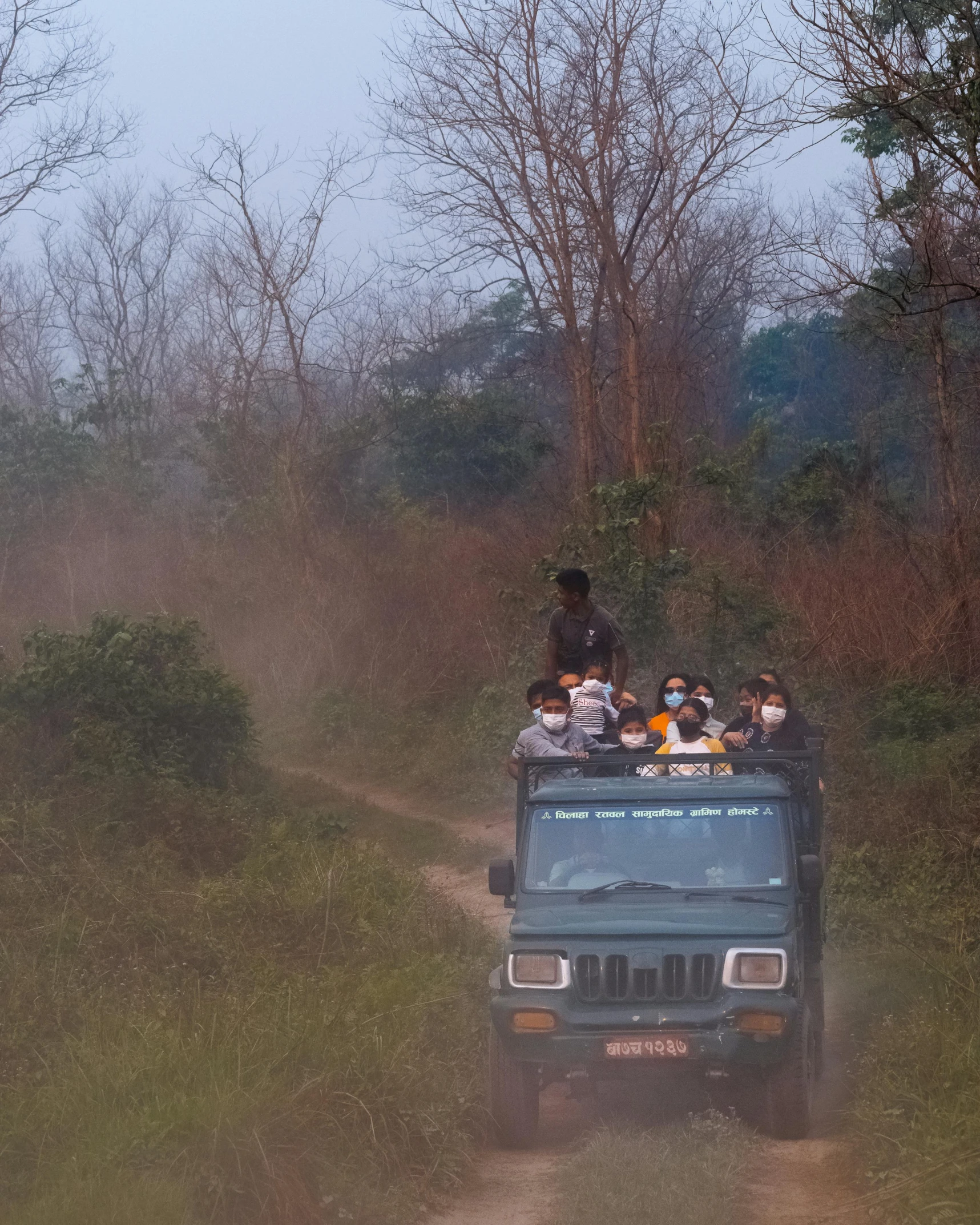 a truck filled with people driving down a dirt road, assamese aesthetic, wildlife photo, thumbnail, multiple stories