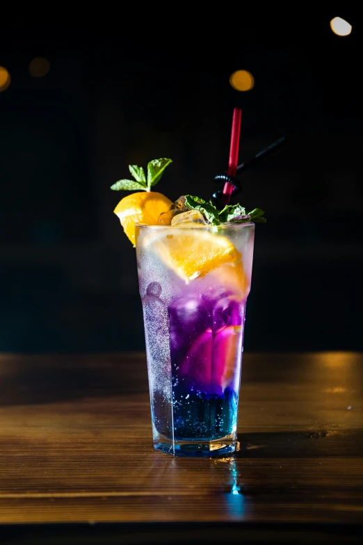 a purple drink sitting on top of a wooden table, a colorized photo, trending on pexels, multi colored, sparkling spirits, half moon, ivy's
