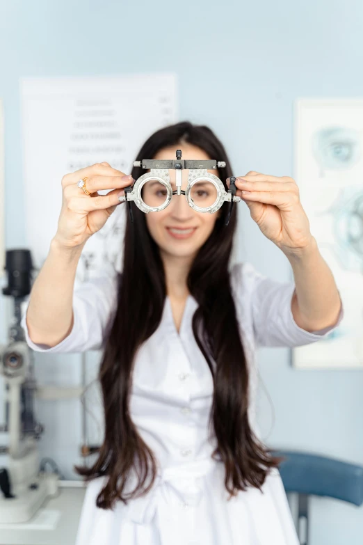 a woman is looking through a pair of glasses, a picture, wearing lab coat and a blouse, with multiple eyes, premium quality, medium-shot