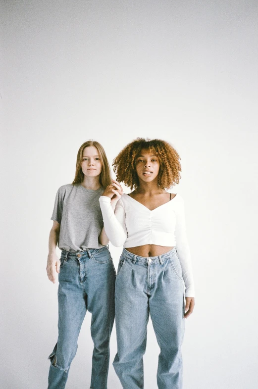 a couple of women standing next to each other, trending on pexels, renaissance, ( ( ( wearing jeans ) ) ), mixed race, pale - skinned, wearing crop top