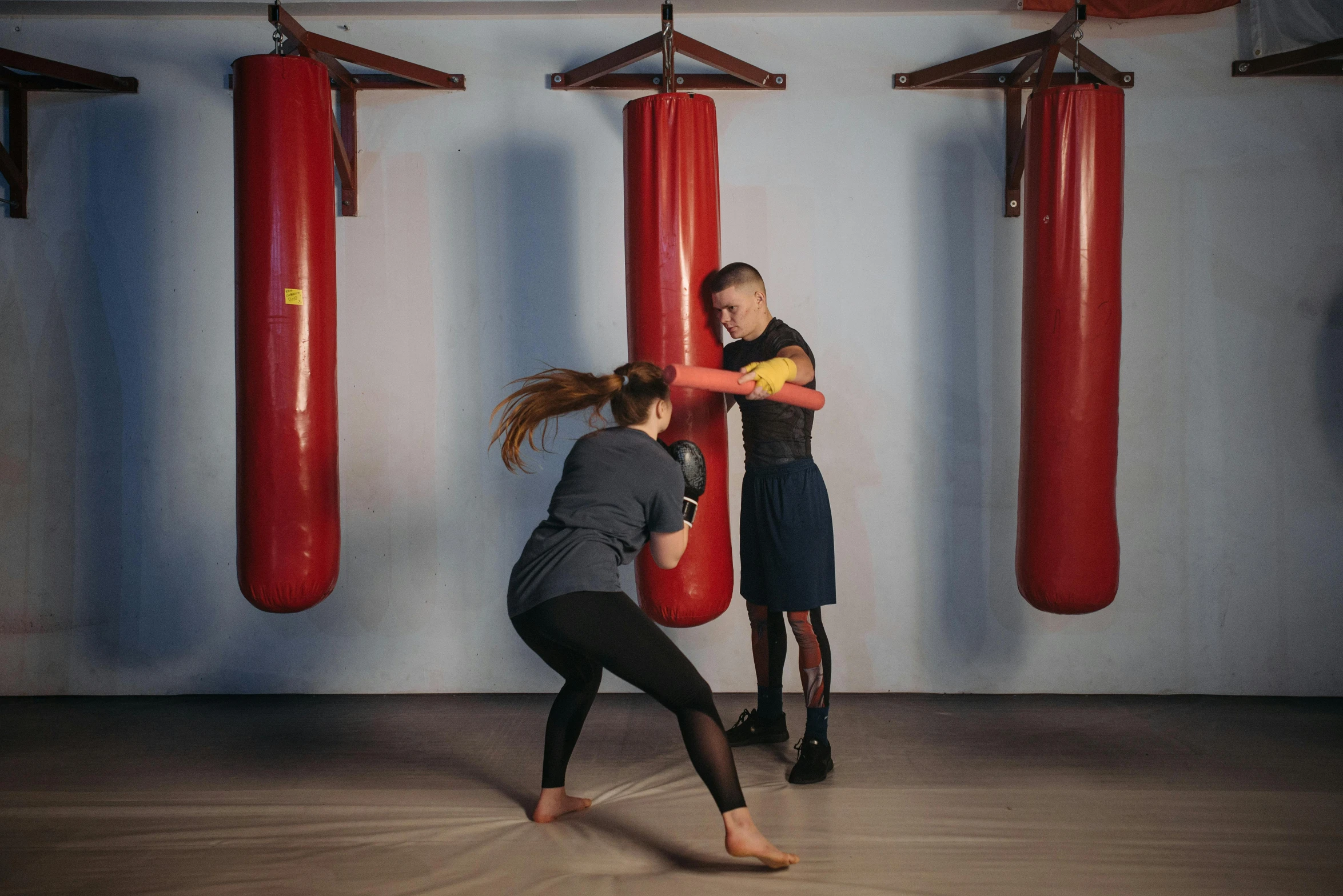 a man and a woman boxing in a gym, by Emma Andijewska, advertising photo, cardboard, distant photo, small